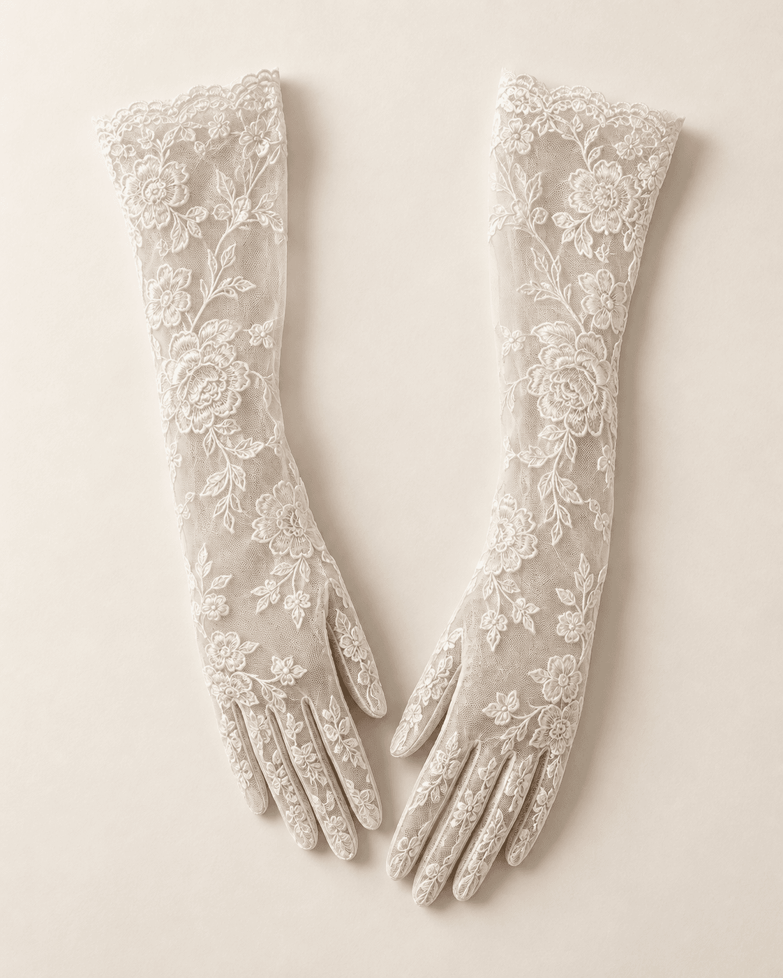 Ivory lace bridal gloves arranged as a studio fashion still life